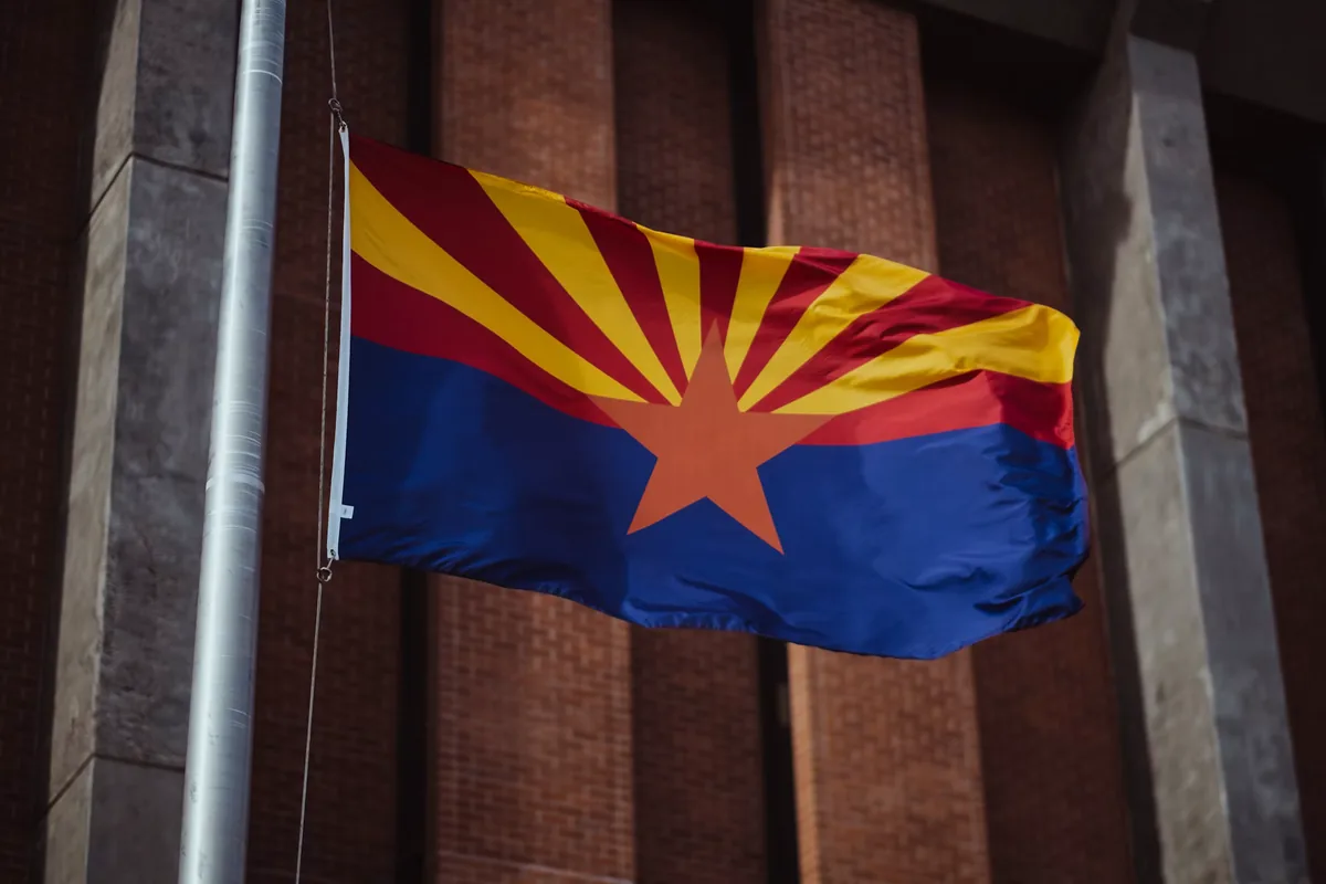 The Arizona state flag flying outside a downtown building — best sporting clays ranges in Arizona