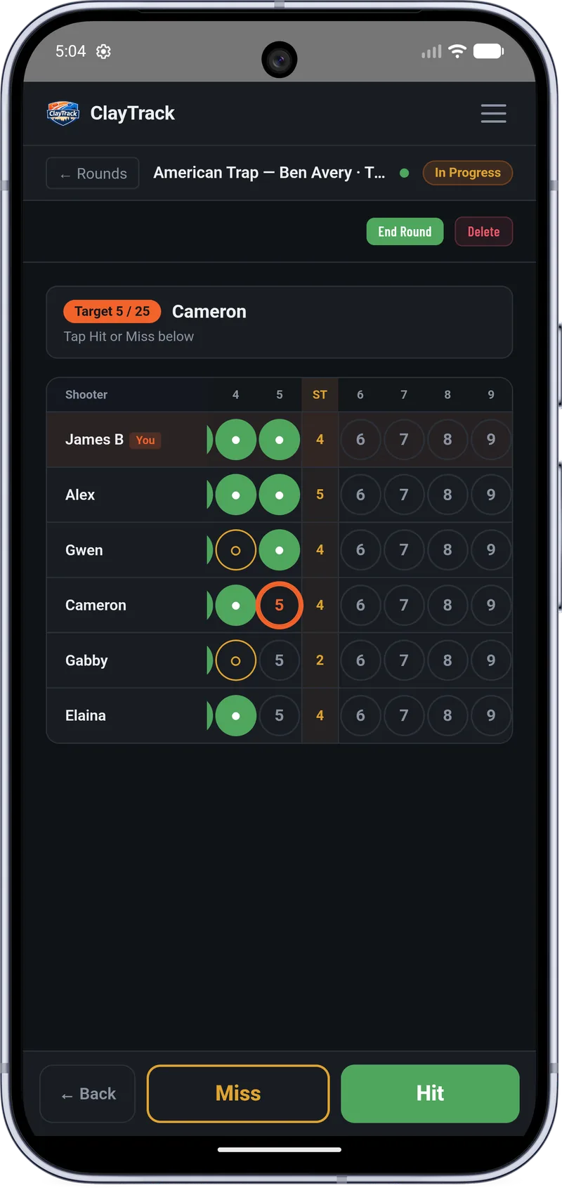 ClayTrack on a phone — a live American Trap scorecard at Ben Avery with a six-shooter squad, hits and misses marked and station subtotals totalling themselves